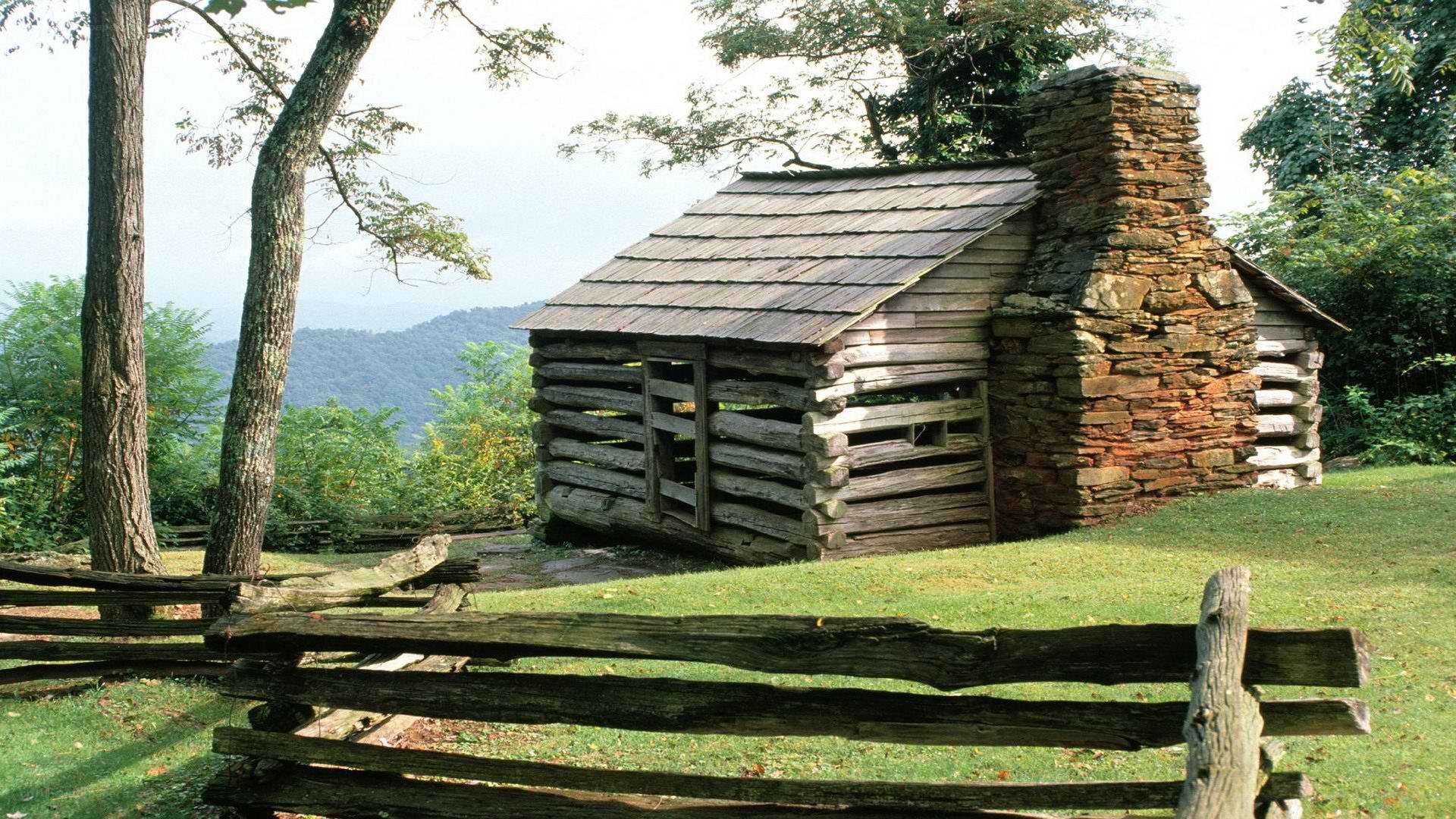 Old log cabin in mountain valley