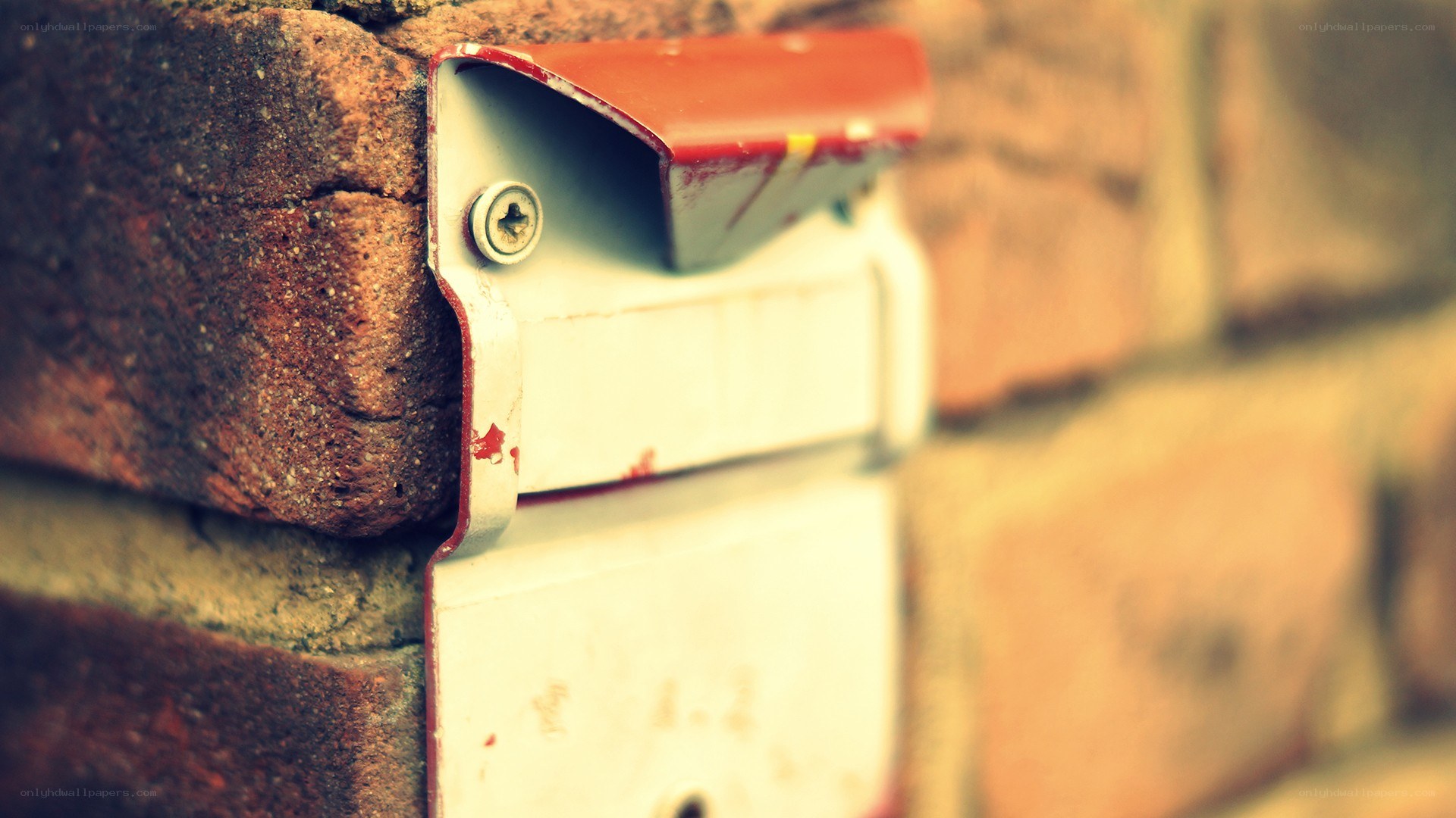 old mailbox on brick wall