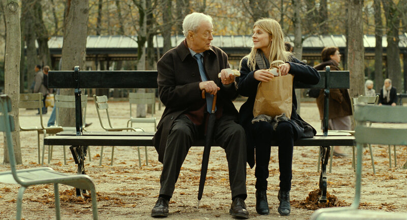 Old man and young woman on bench
