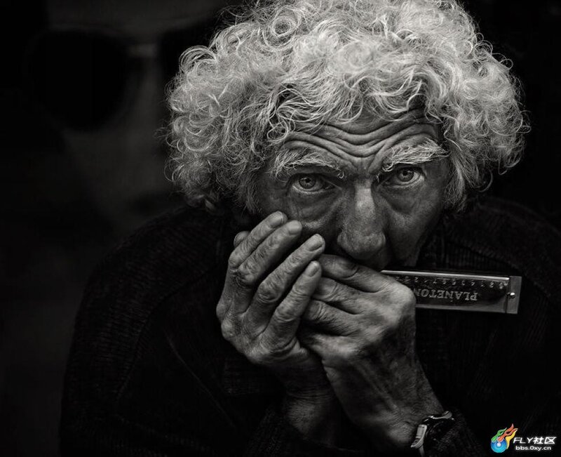Old man playing harmonica