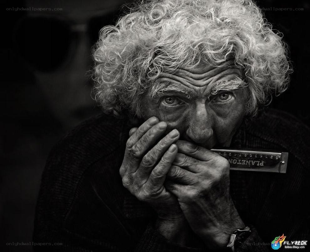 Old man playing harmonica