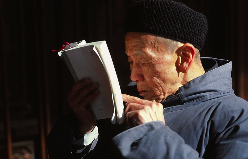 Old man reading a book