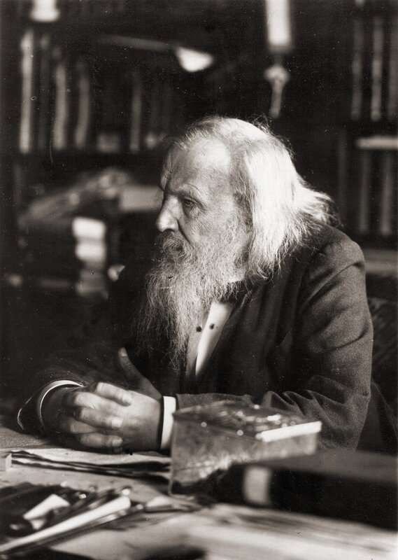 Old man with long beard at desk