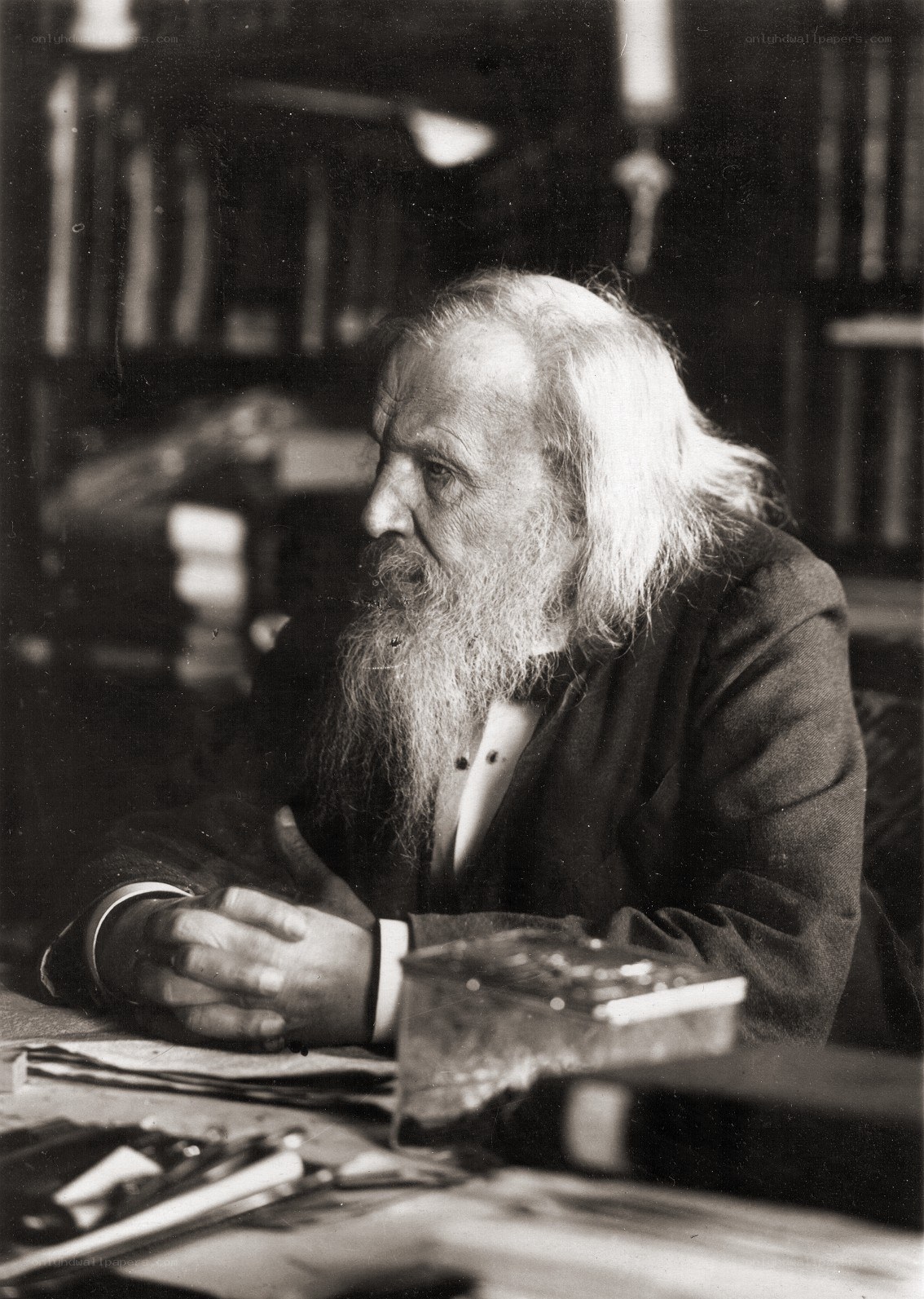 Old man with long beard at desk