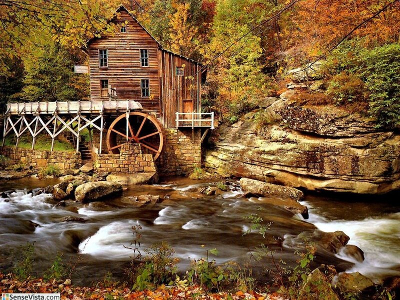 Old mill by a river in autumn