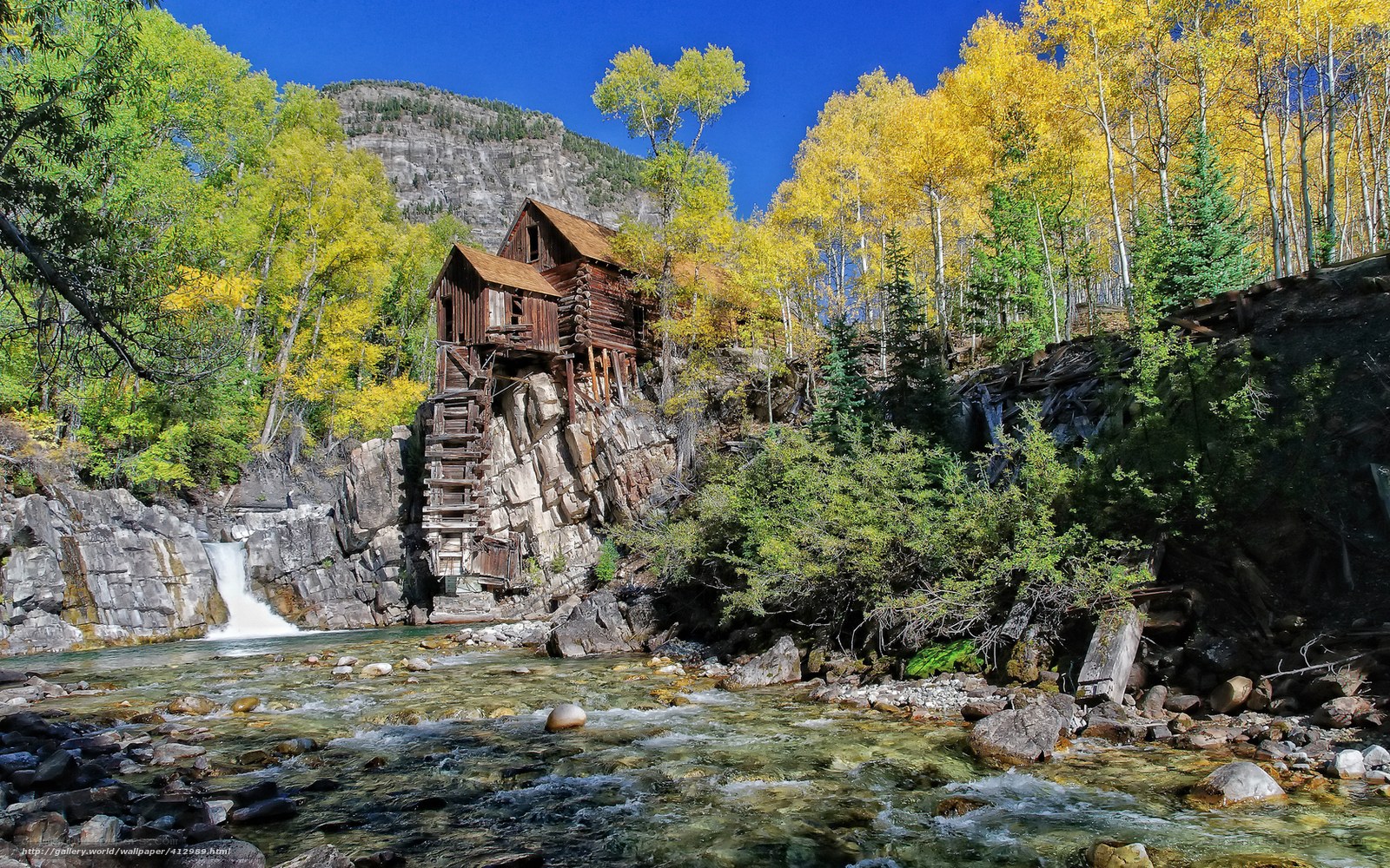 Old mill by a river in autumn