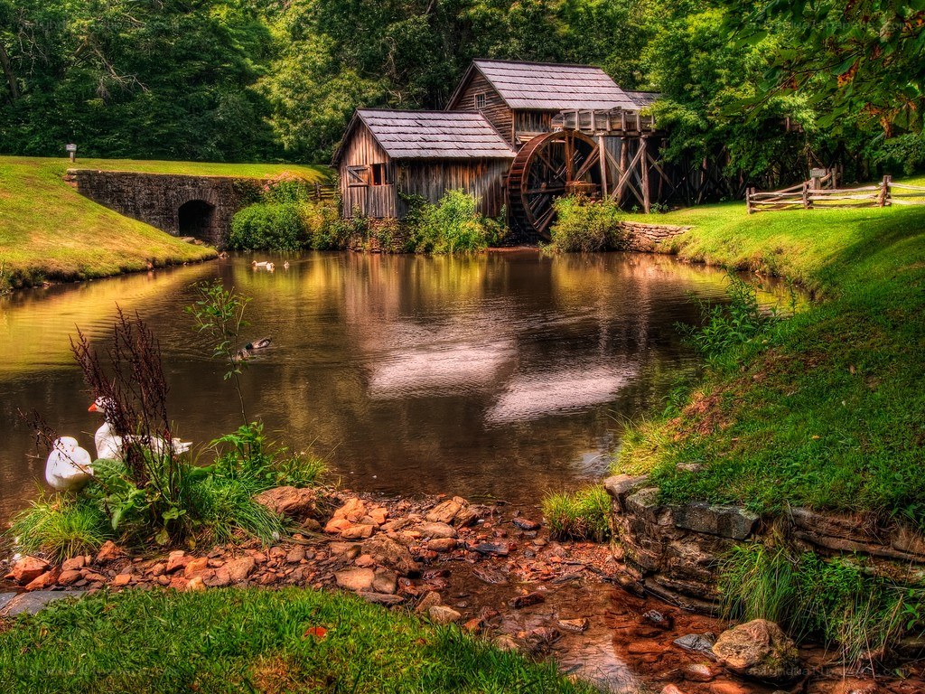 Old mill by a serene pond