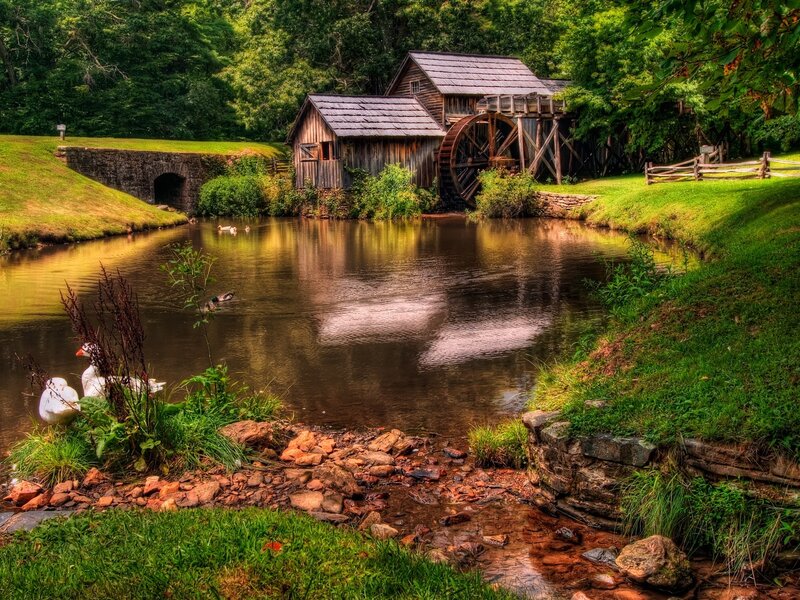Old mill by a serene pond