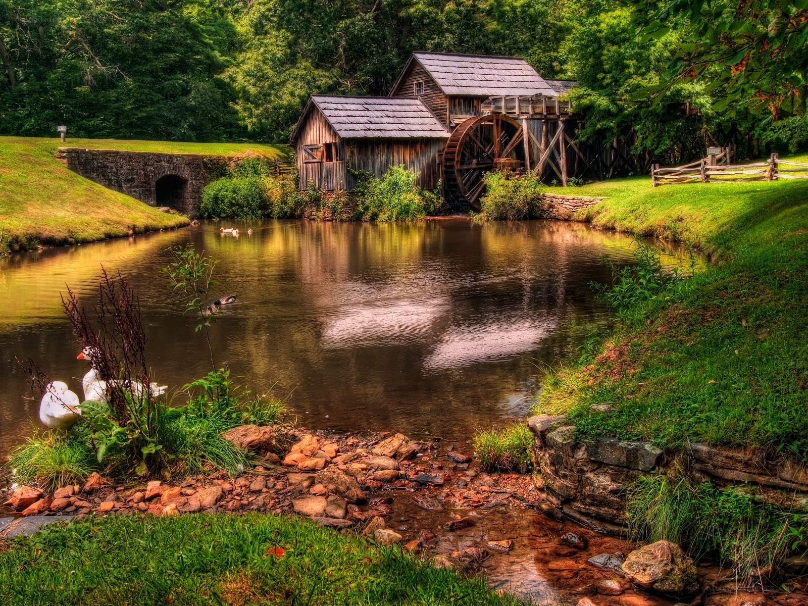 Old mill by a serene pond