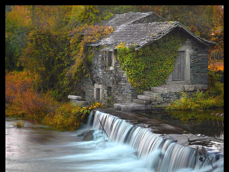 Old mill by a waterfall