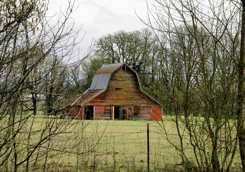 Old red barn in a rural field
