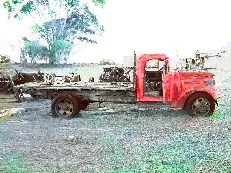 old red truck in field