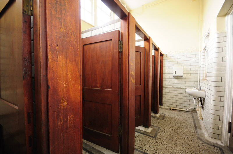 Old restroom with wooden stalls