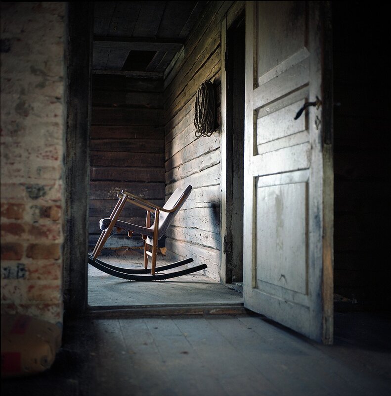 Old rocking chair in a dark hallway