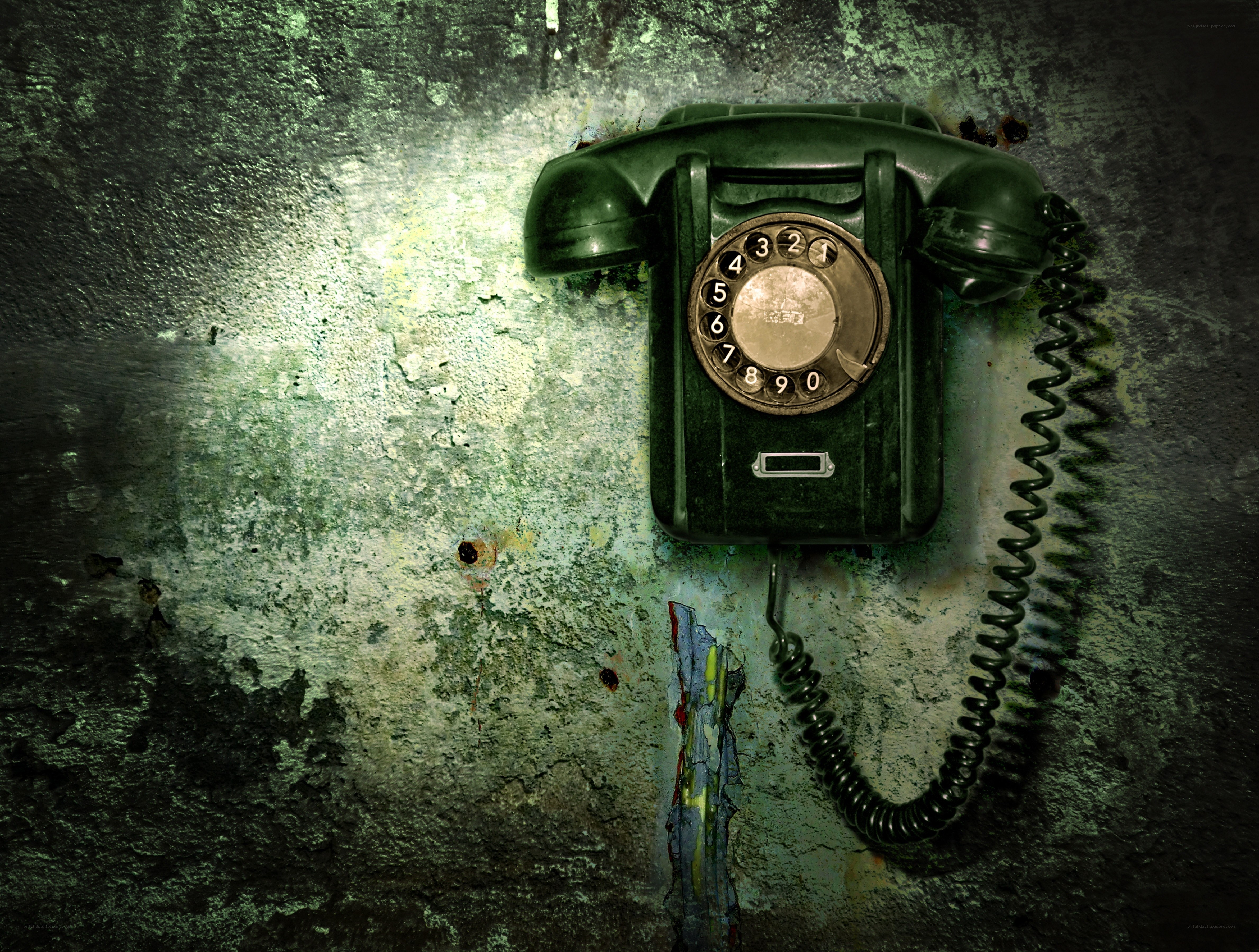 old rotary phone on decaying wall