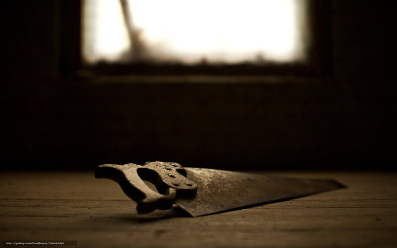 Old saw on wooden surface