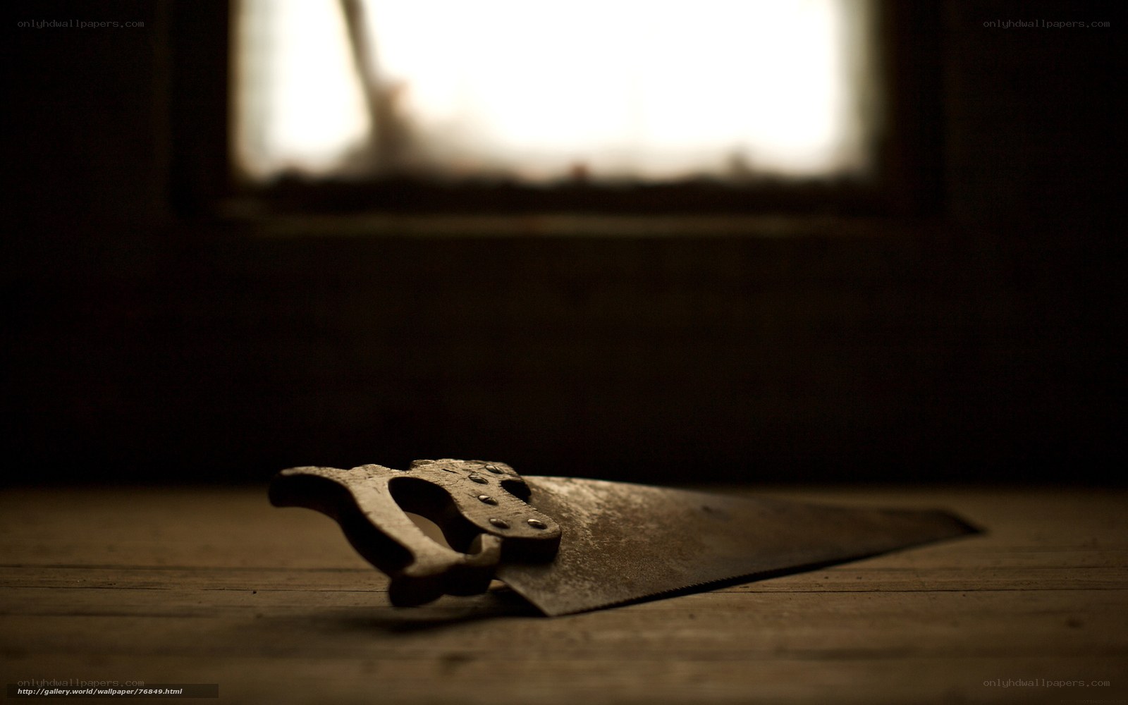 Old saw on wooden surface