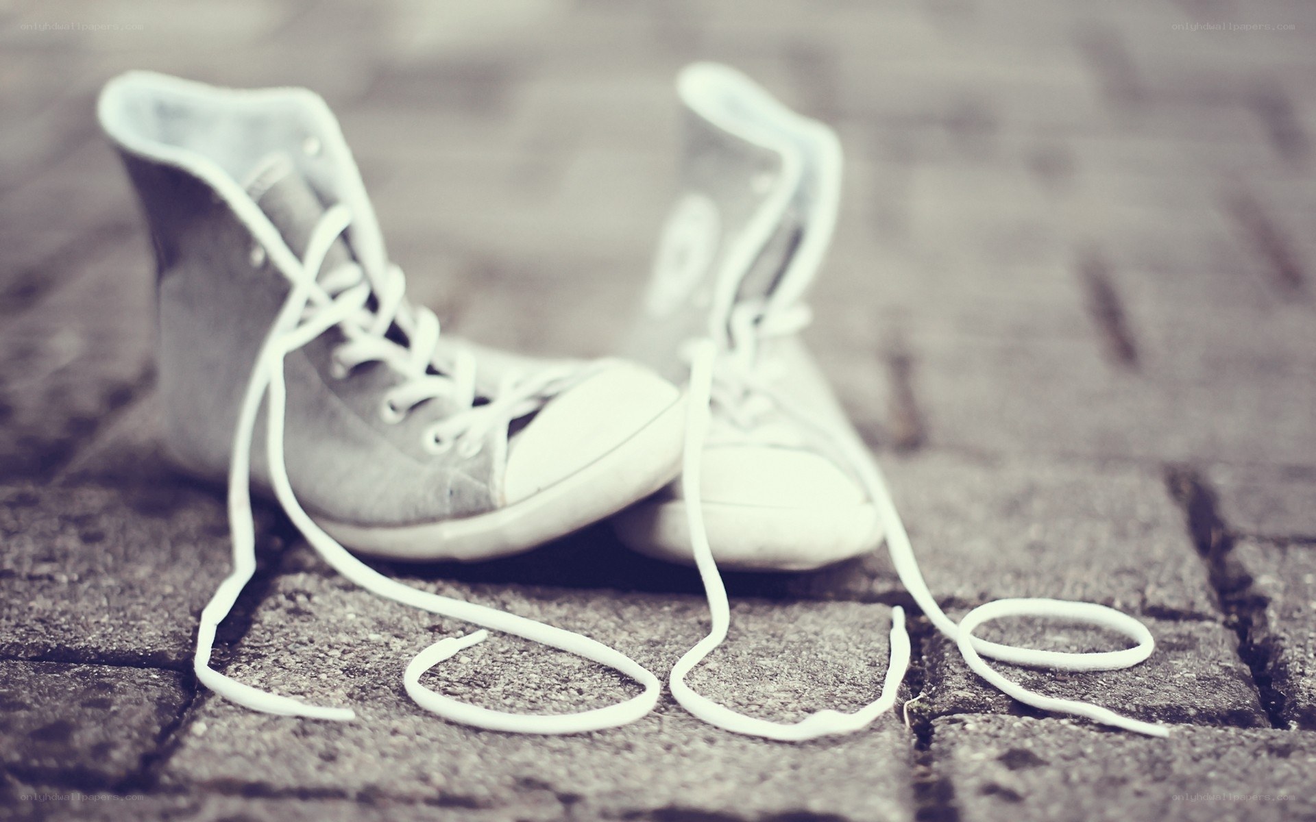 Old sneakers on pavement