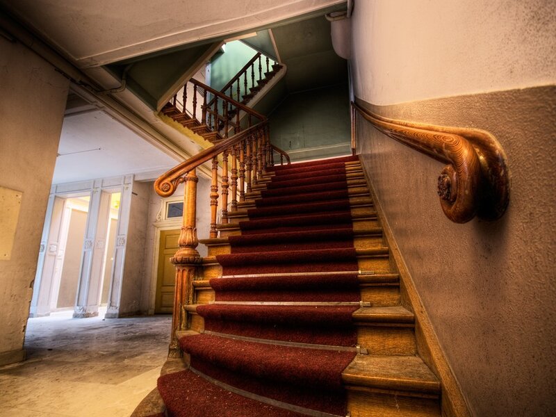 Old staircase with red carpet