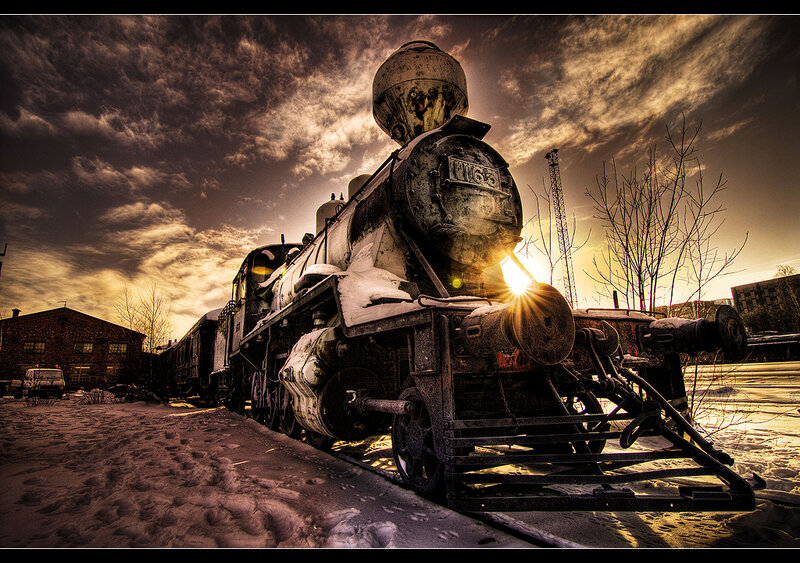 Old steam locomotive at sunset
