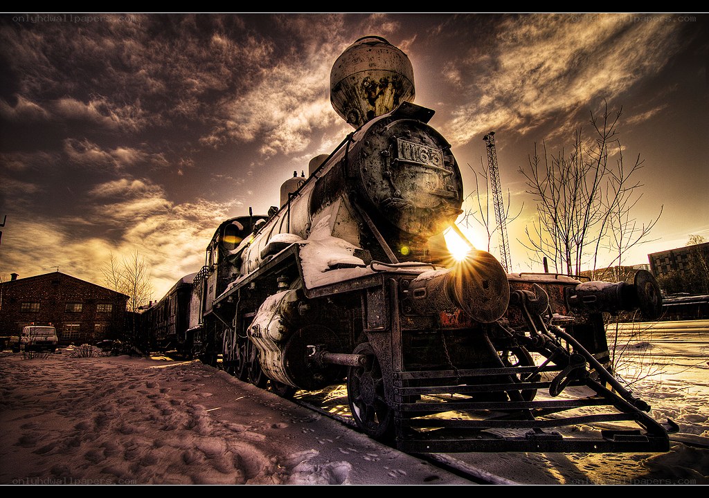 Old steam locomotive at sunset
