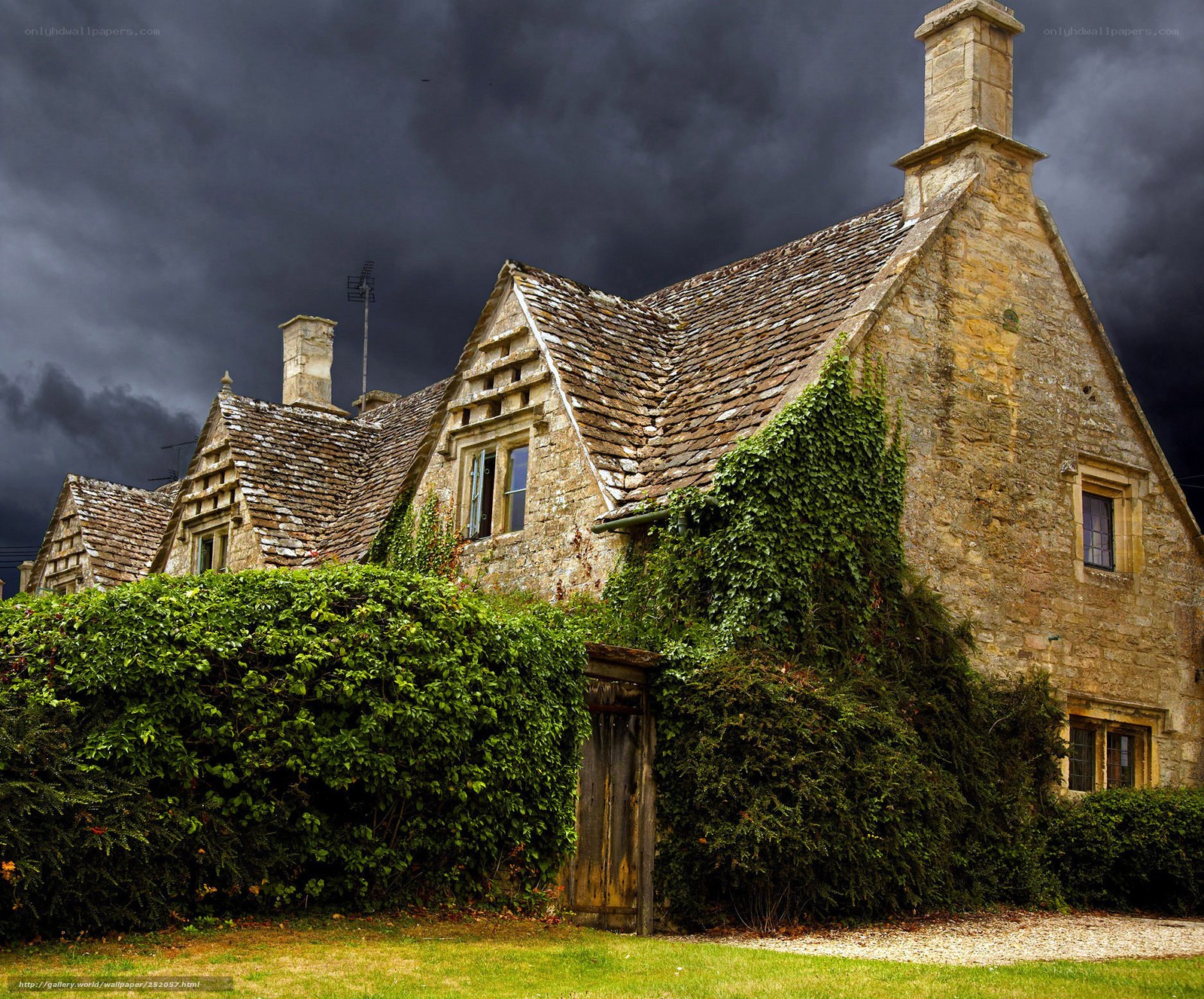 Old stone cottage under stormy sky