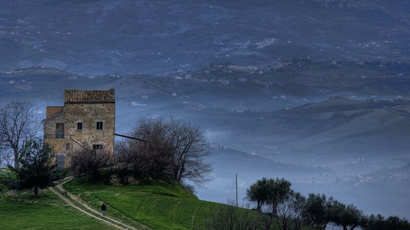 Old stone house on a misty hill