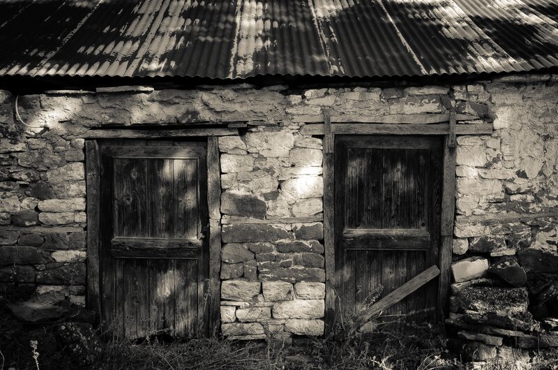 Old stone shed with wooden doors