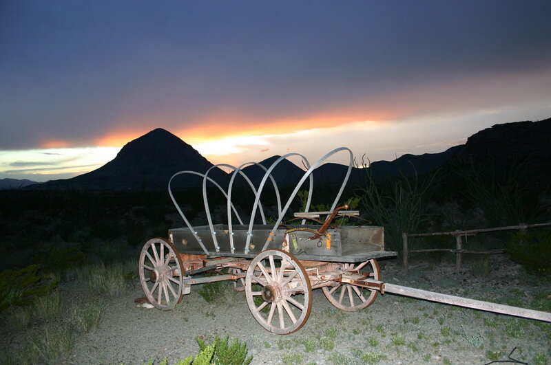 Old wagon at sunset in desert
