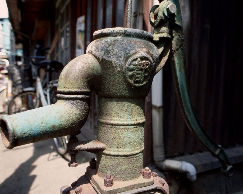 old water pump in alley