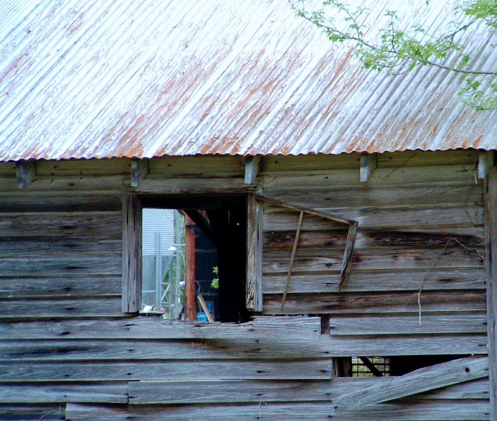 Old weathered barn with broken window
