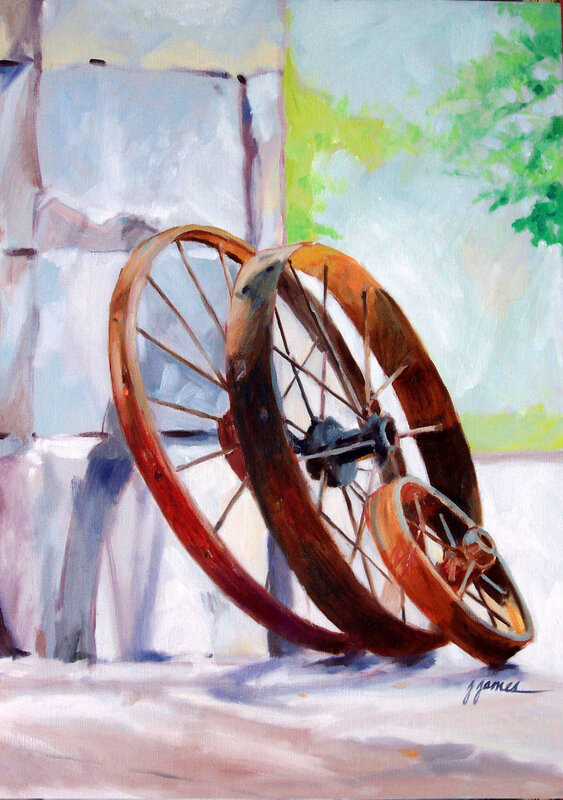 Old wheels leaning against wall
