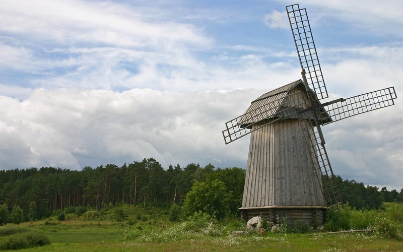 Old windmill in a green field