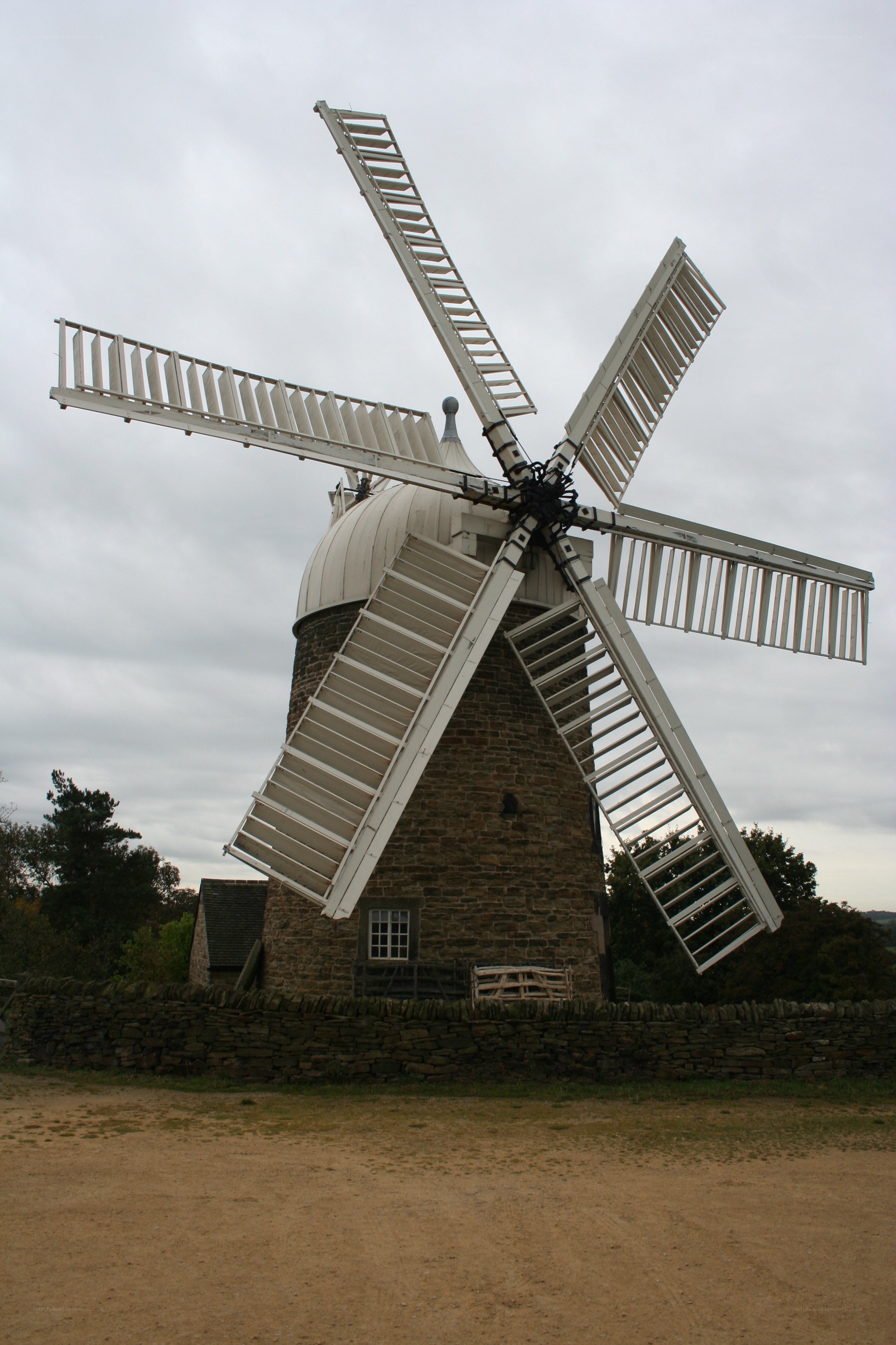 Old windmill with white sails