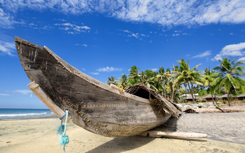 Old wooden boat on tropical beach