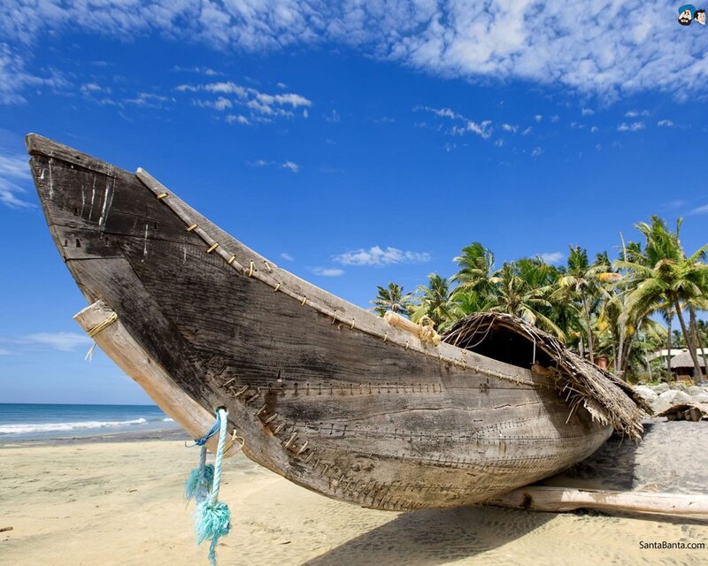 Old wooden boat on tropical beach
