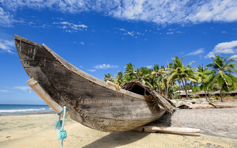 Old wooden boat on tropical beach