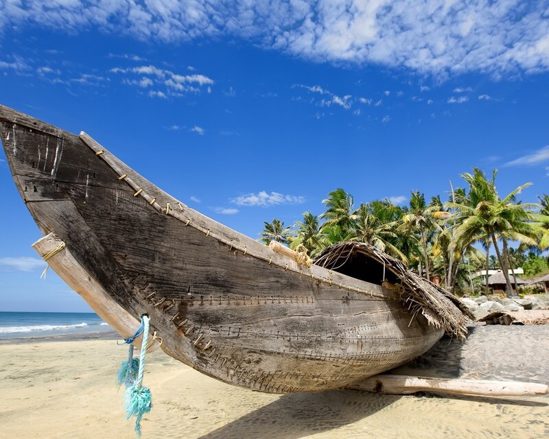 Old wooden boat on tropical beach