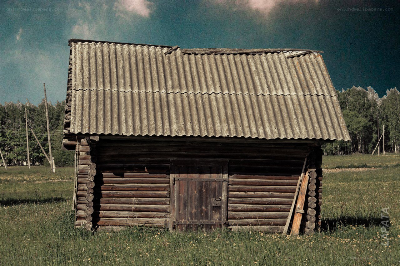 Old wooden cabin in a field