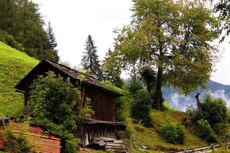 Old wooden cabin in a mountain valley
