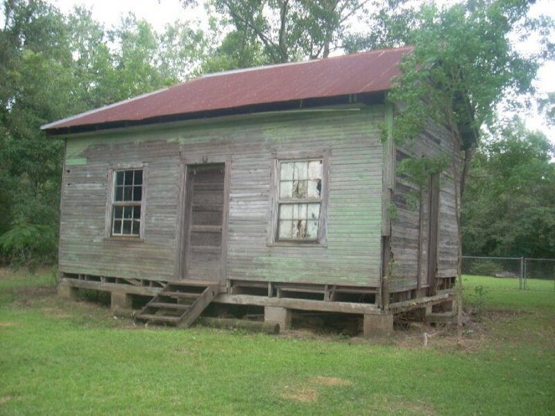 old wooden cabin in grass
