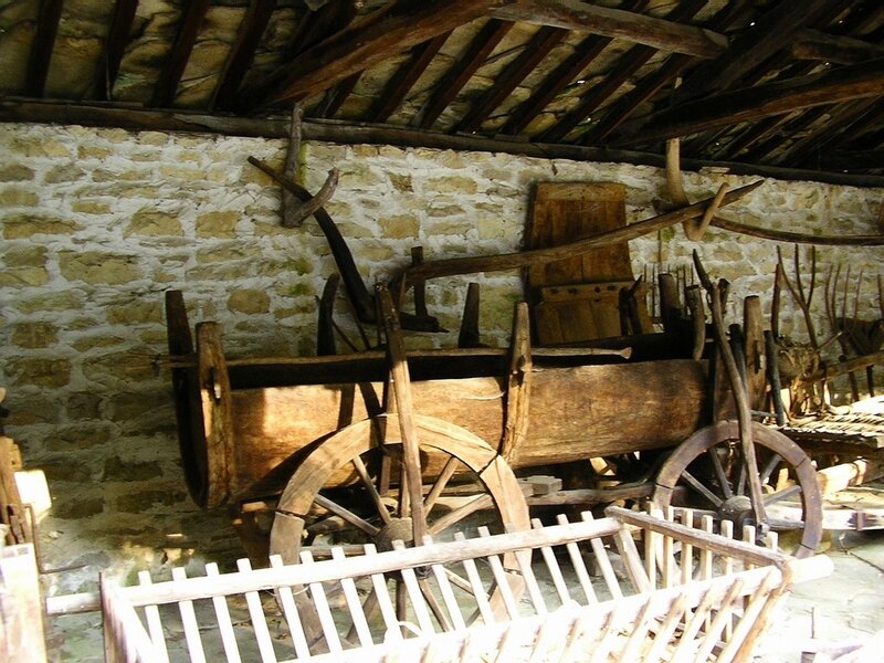 Old wooden cart in a stone shed