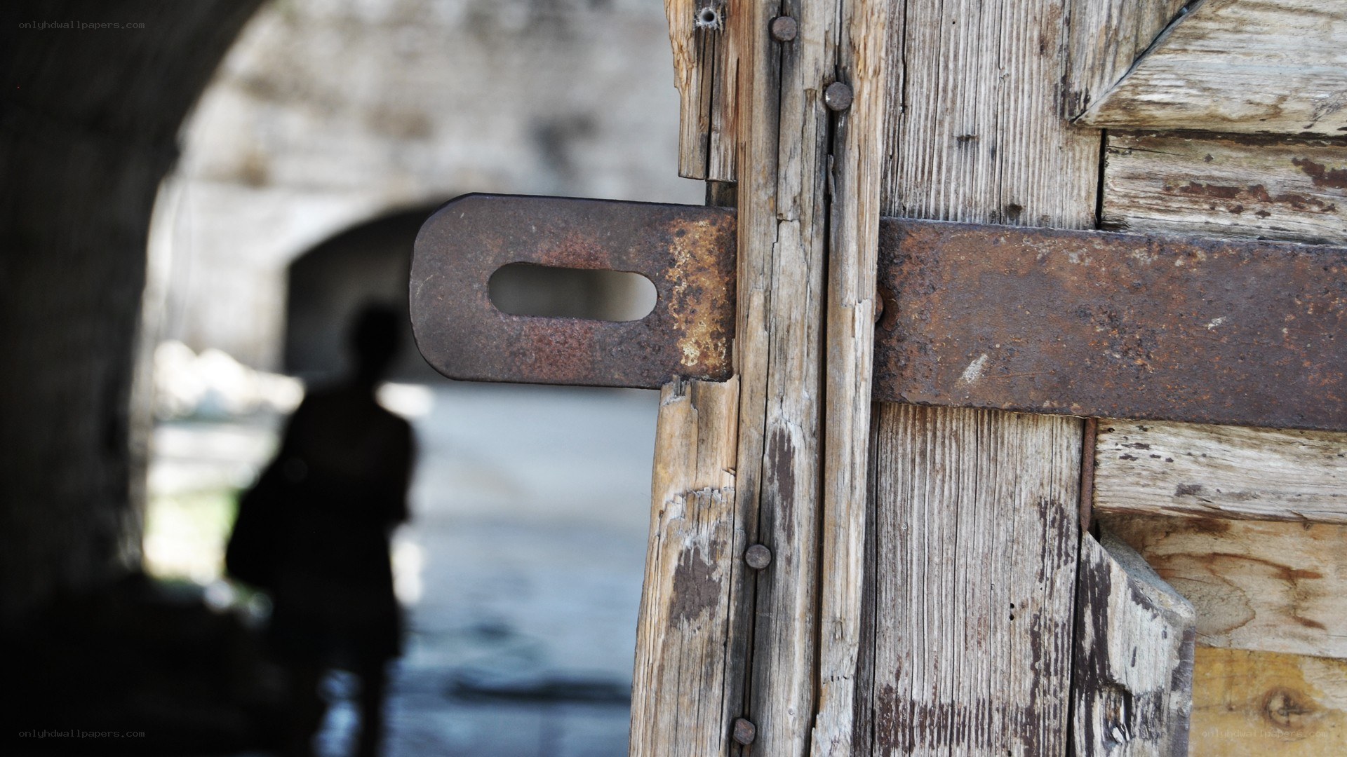 old wooden door with rusty latch