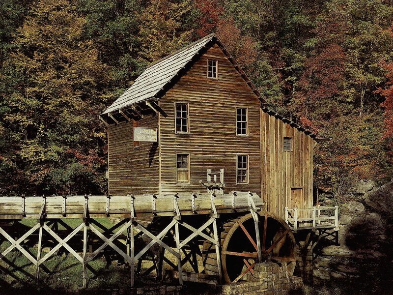 Old wooden mill in autumn forest