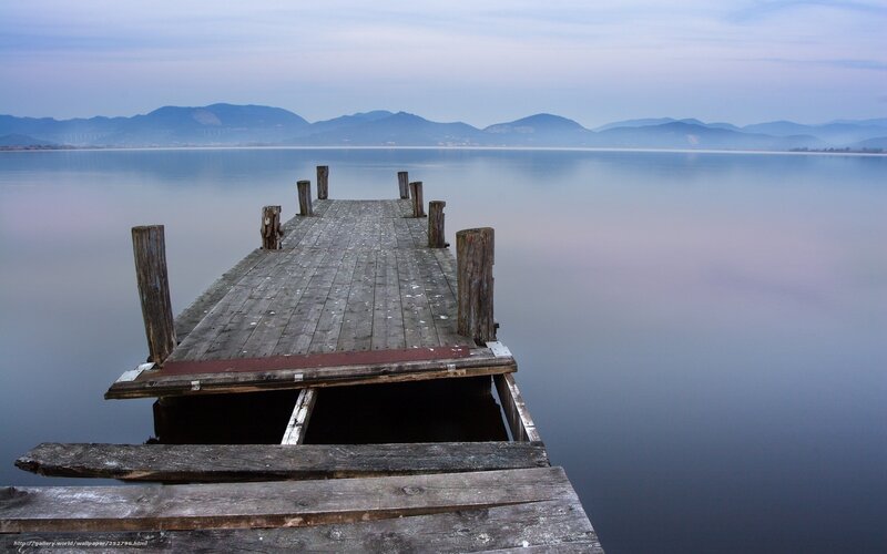 Old wooden pier on calm lake