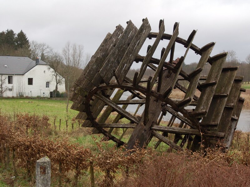 Old wooden waterwheel by a river