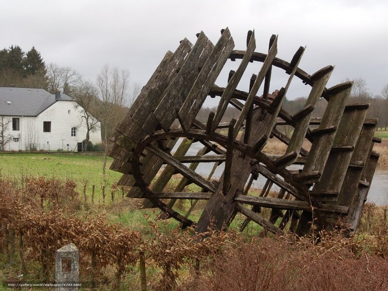 Old wooden waterwheel by river