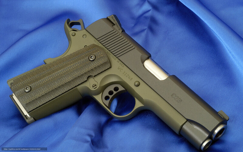 Olive-drab pistol on blue cloth