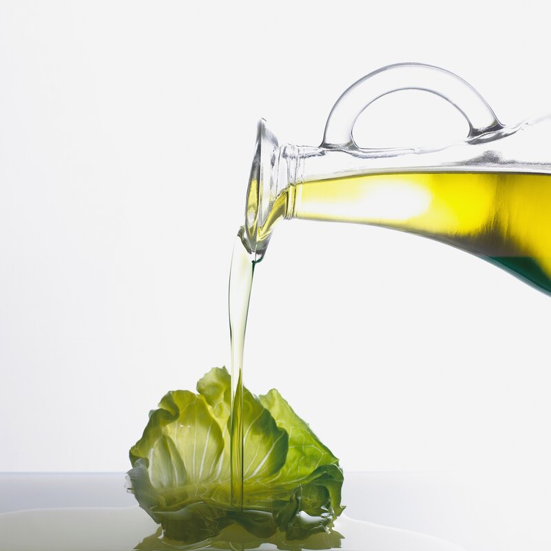 olive oil poured on lettuce