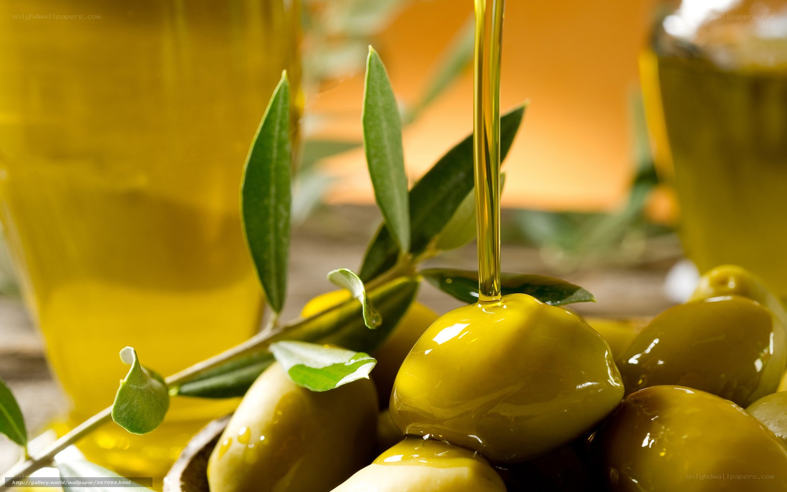 Olive oil pouring over olives